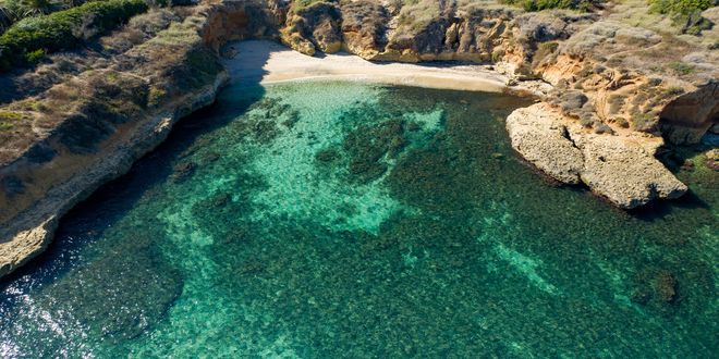 Aerial view of the coast and turquoise sea of Porto Torres, Sardinia, Italy
