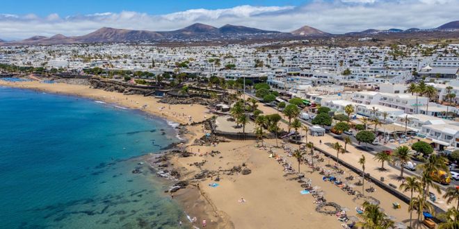 Coastal buildings and clear blue waters in Puerto del Carmen, Lanzarote, Canary Islands