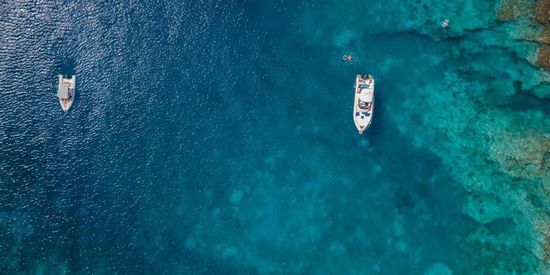 Ferries floating on the crystal-clear waters of the Sporades in Greece