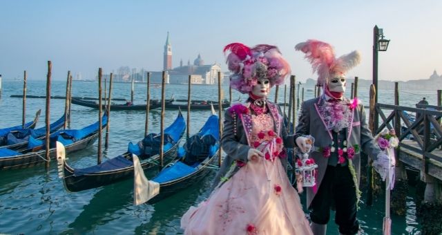 Locals in traditional Venetian costumes near the pier