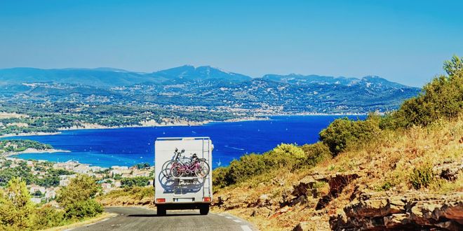 Motorhome traveling on a scenic road near the coast, in Italy