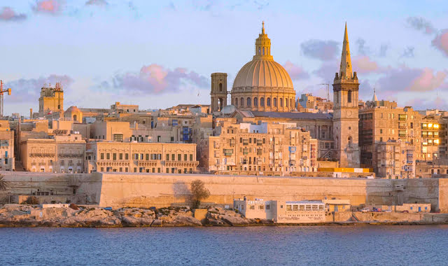 Sunset over historic buildings in downtown Valletta, Malta