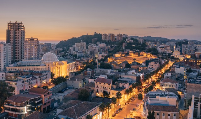 View of downtown Durrës, Albania, at dusk with the sea in the distance