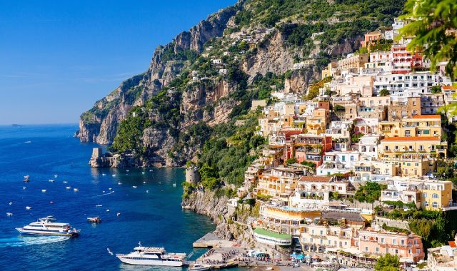 Colorful houses of Positano perched on rocky cliffs by the sea
