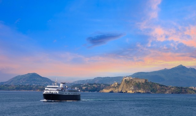 Scenic sunset over the island of Procida near Naples as ferry leaves