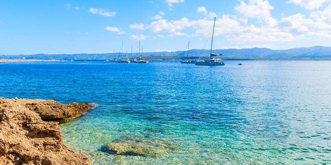 Boats close to a beach of the island of Brač in Croatia