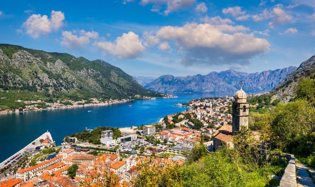 A bell tower rises among the historic buildings of the city of Kotor, Montenegro